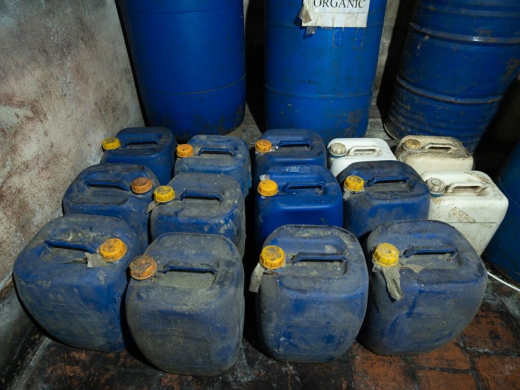 Stacked blue and white plastic containers, likely for storage.